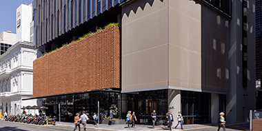 Commercial building exterior street level with pedestrians