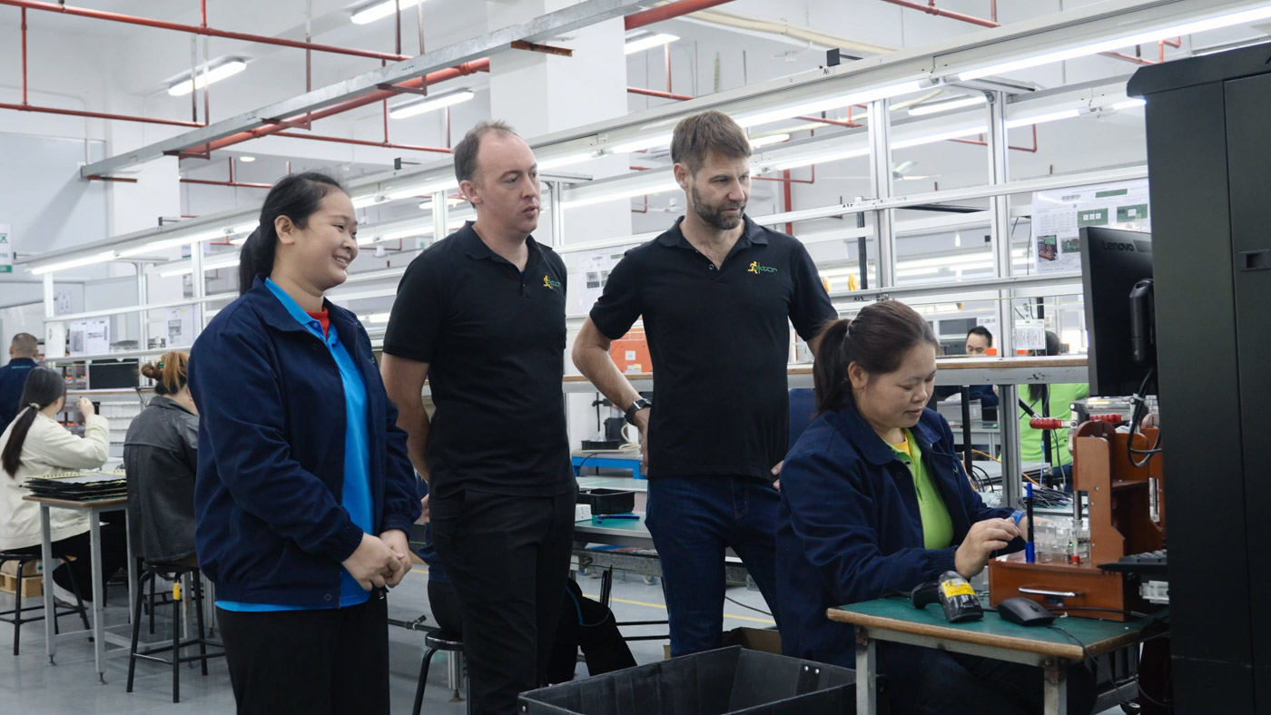 Factory management and staff observing manufacturing
