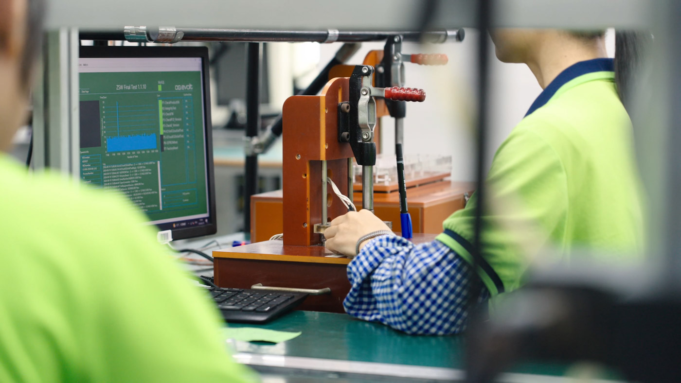 Skilled factory worker testing electronics