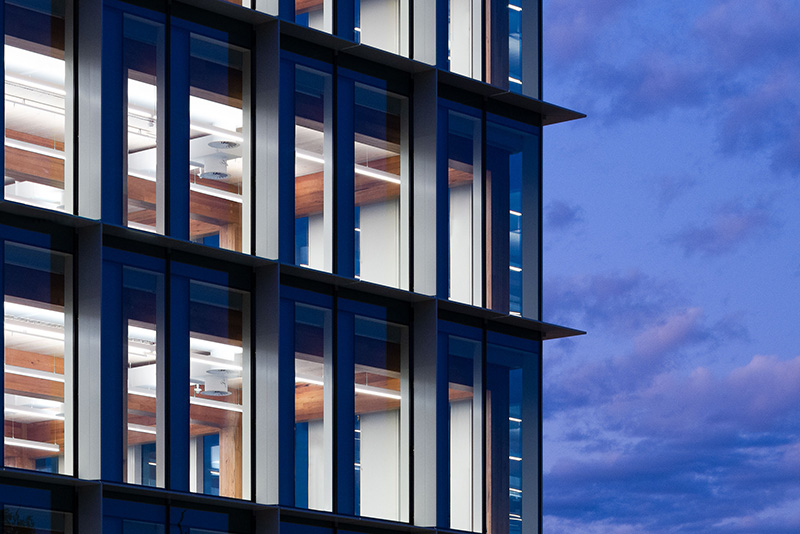 Commercial building close up of exterior in evening showing interior lighting